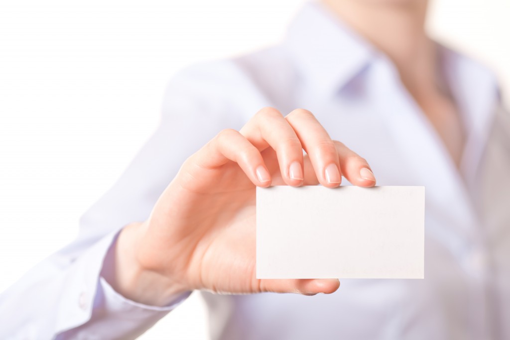 Business women handing a blank business card